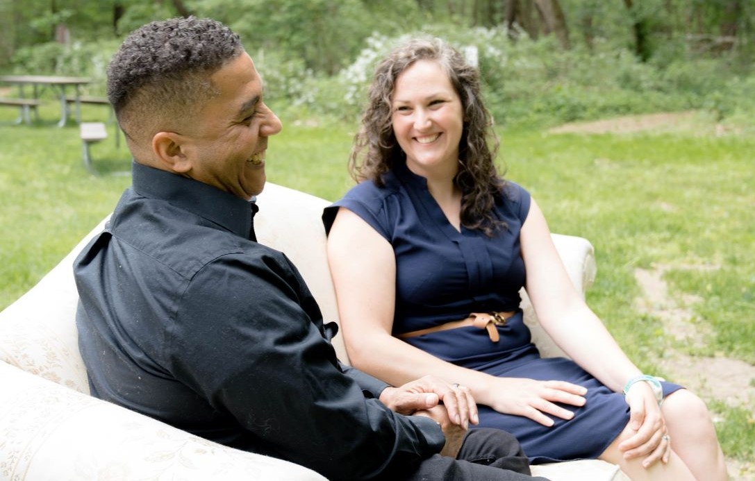 birth mother and adult transracial adoptee sitting on the sofa, talking about their adoption experiences